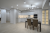 wnetrze-nowej-przestronnej-bialej-kuchni-po-remoncie-w-apartamentach-typu-studio.png